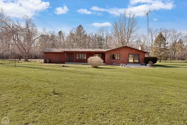 rear view of property featuring a yard