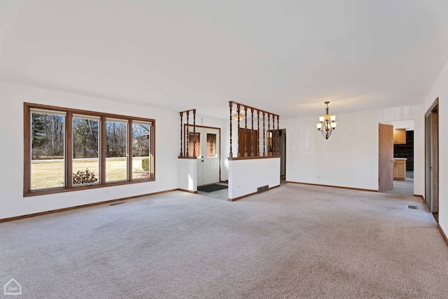 unfurnished living room featuring carpet and a notable chandelier