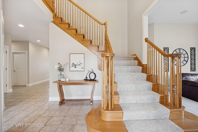 stairs featuring tile patterned flooring, baseboards, and recessed lighting