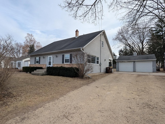 view of front facade with a garage and an outdoor structure