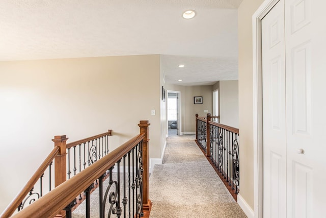 corridor featuring light colored carpet