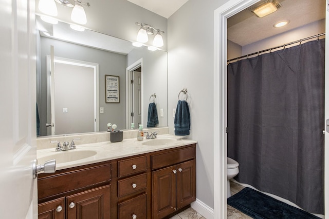 bathroom with tile patterned floors, vanity, and toilet