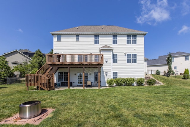 back of property with a wooden deck, a yard, and a patio area