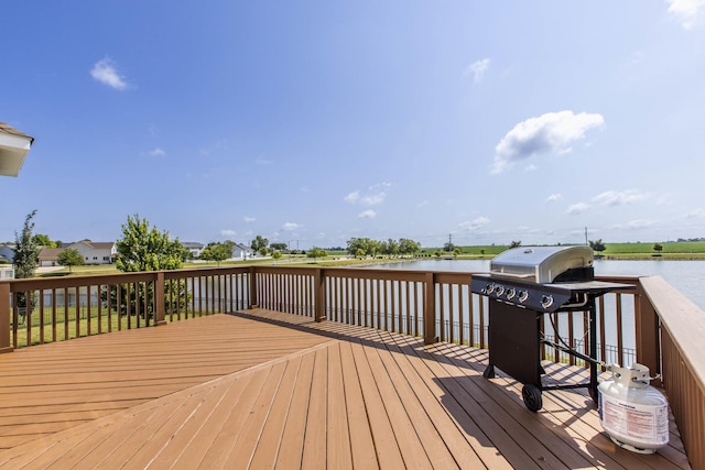 deck with a water view and grilling area