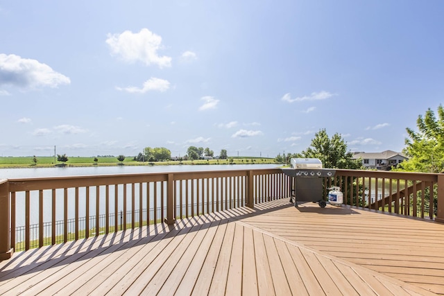 wooden terrace featuring area for grilling and a water view