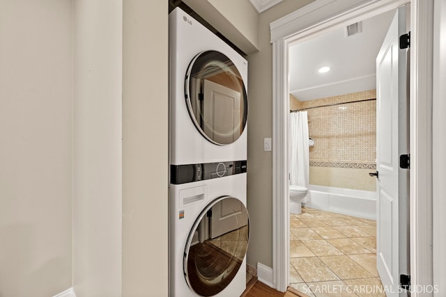 714 Walnut Dr Unit 109, Darien, IL 60561 - washroom with visible vents, tile patterned floors, stacked washer and clothes dryer, and laundry area