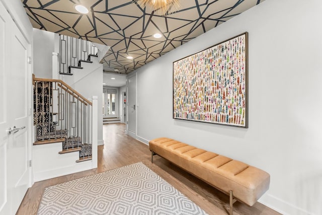 foyer featuring stairway, baseboards, wood finished floors, and recessed lighting