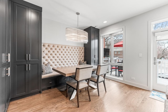 dining space featuring breakfast area, plenty of natural light, light wood-style flooring, and baseboards