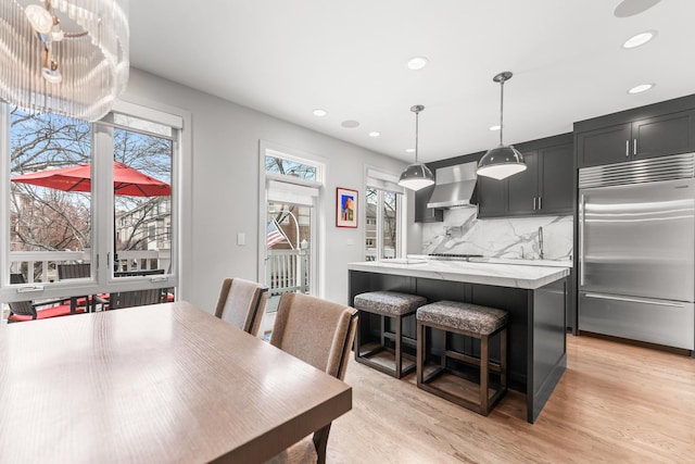 dining space with recessed lighting and light wood finished floors