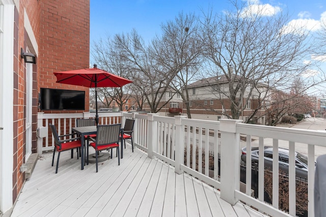 wooden terrace with outdoor dining space