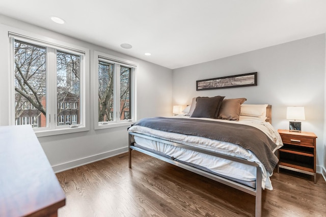 bedroom with recessed lighting, baseboards, and wood finished floors