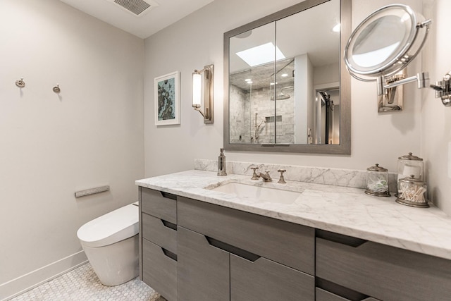 full bathroom featuring a stall shower, baseboards, visible vents, toilet, and vanity