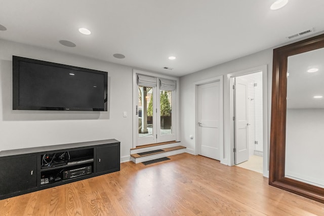 unfurnished living room with baseboards, visible vents, wood finished floors, and recessed lighting