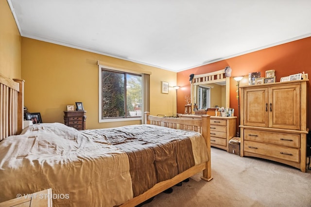 bedroom with crown molding and light colored carpet