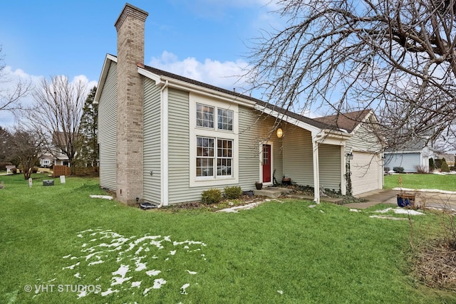 view of front of property featuring an attached garage, a chimney, and a front lawn