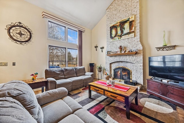 living area featuring high vaulted ceiling and a fireplace