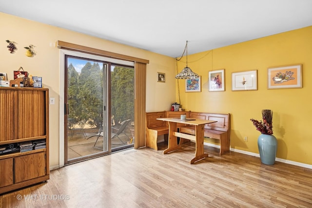 dining room with light wood-style floors and baseboards