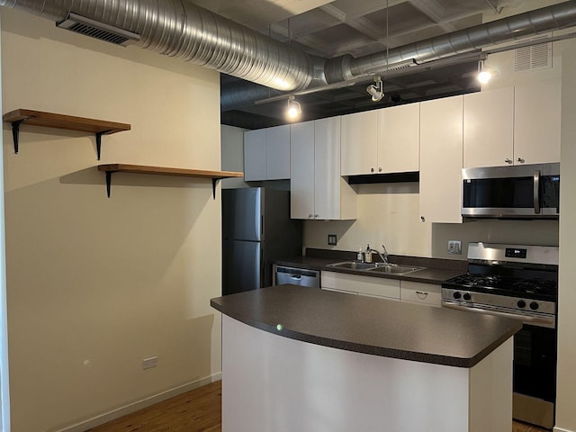 kitchen featuring a kitchen island, appliances with stainless steel finishes, sink, white cabinets, and light hardwood / wood-style floors