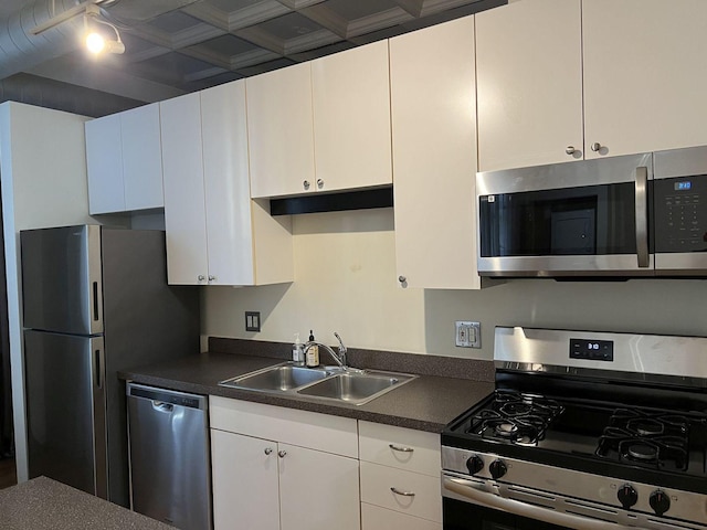 kitchen featuring stainless steel appliances, white cabinetry, and sink