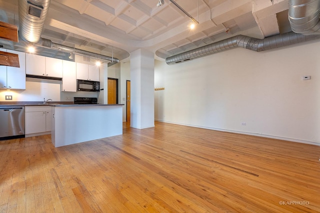 kitchen with white cabinetry, range, stainless steel dishwasher, a towering ceiling, and light hardwood / wood-style floors