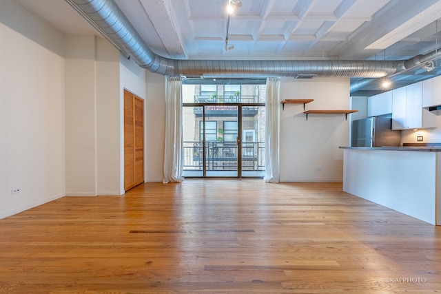 unfurnished living room featuring light hardwood / wood-style floors