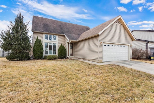 view of front of house with driveway, a front lawn, roof with shingles, and an attached garage