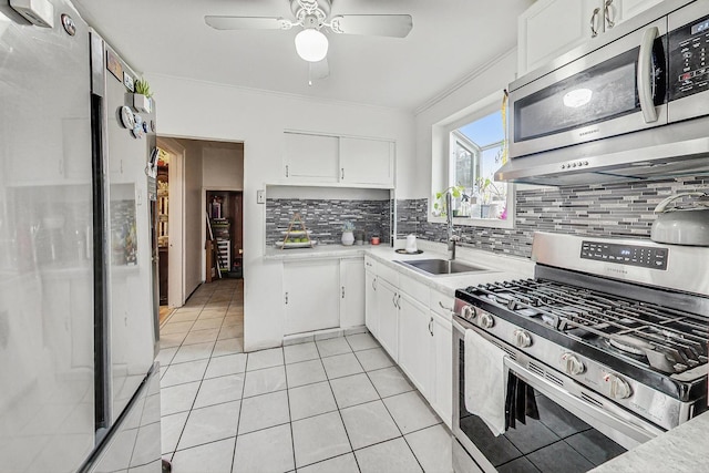 kitchen with white cabinetry, appliances with stainless steel finishes, sink, and tasteful backsplash