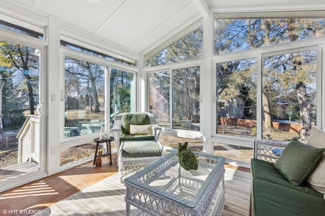 sunroom / solarium with lofted ceiling with beams