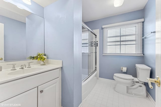 bathroom featuring toilet, shower / bath combination with glass door, vanity, baseboards, and tile patterned floors