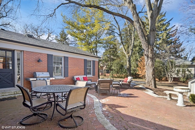 view of patio with outdoor dining space and a grill