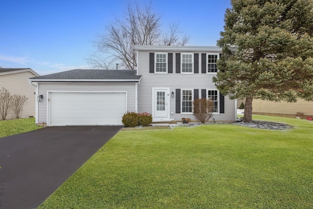 colonial-style house with a garage and a front yard