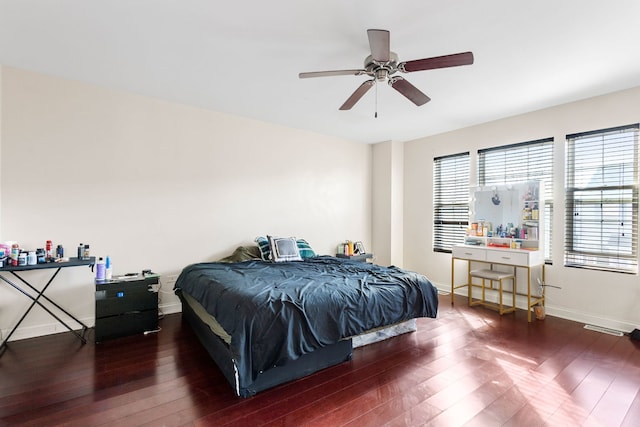 bedroom featuring a ceiling fan, baseboards, and hardwood / wood-style floors