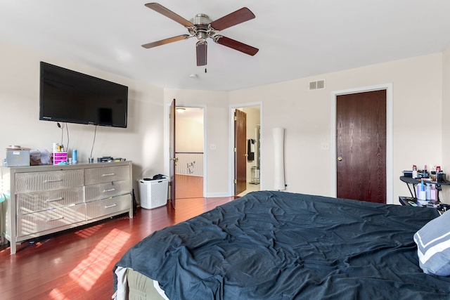 bedroom featuring visible vents, ceiling fan, and wood finished floors