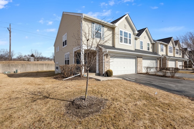 multi unit property featuring driveway and an attached garage