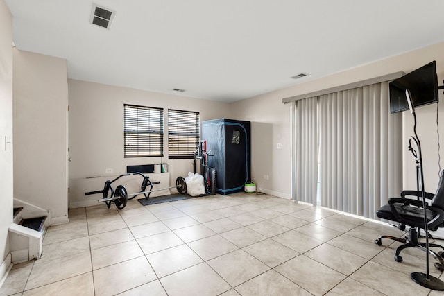 interior space with baseboards, visible vents, and light tile patterned flooring