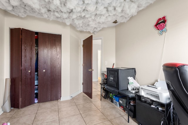 interior space with tile patterned flooring, visible vents, and baseboards