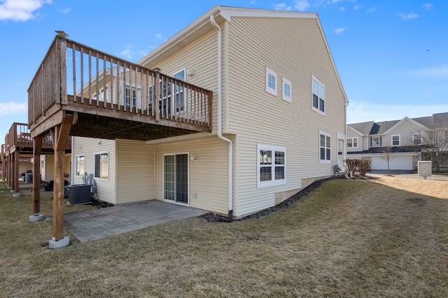 back of house featuring central AC, a yard, a patio area, and a wooden deck