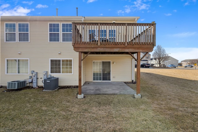 back of property with a patio area, a lawn, a deck, and central air condition unit