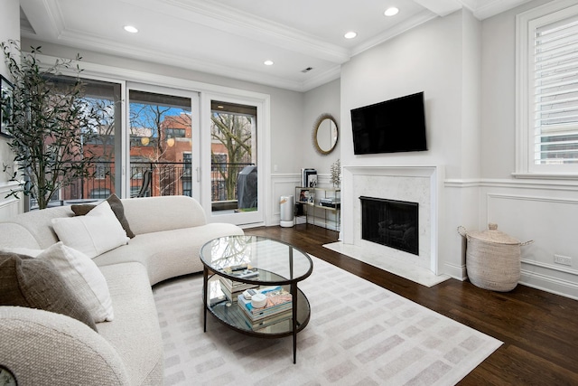 living room featuring ornamental molding, a high end fireplace, and hardwood / wood-style floors