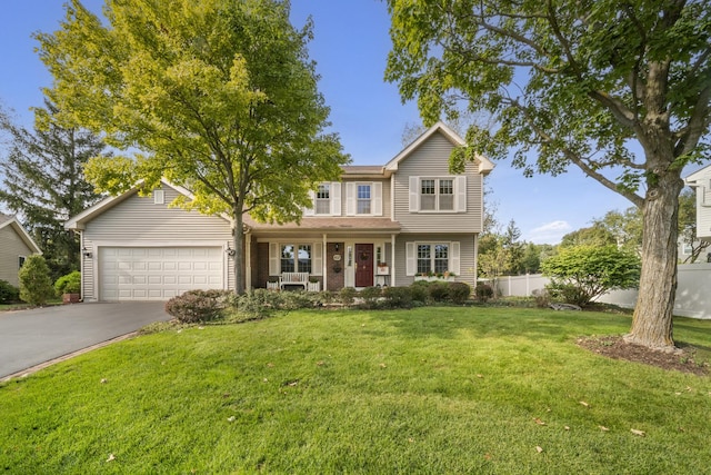 view of property with a porch, a garage, and a front lawn