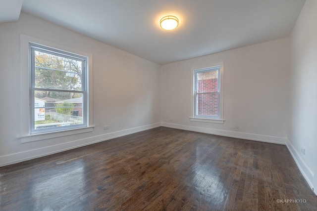 unfurnished room with dark hardwood / wood-style floors