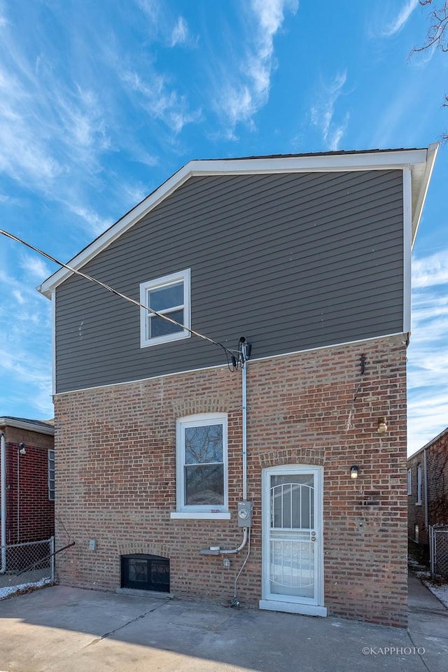 back of property with a patio