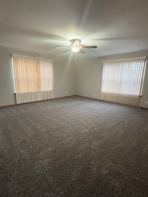 unfurnished room with ceiling fan and carpet flooring