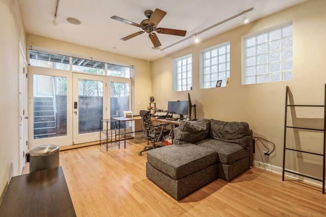 sitting room featuring hardwood / wood-style flooring, track lighting, ceiling fan, and french doors