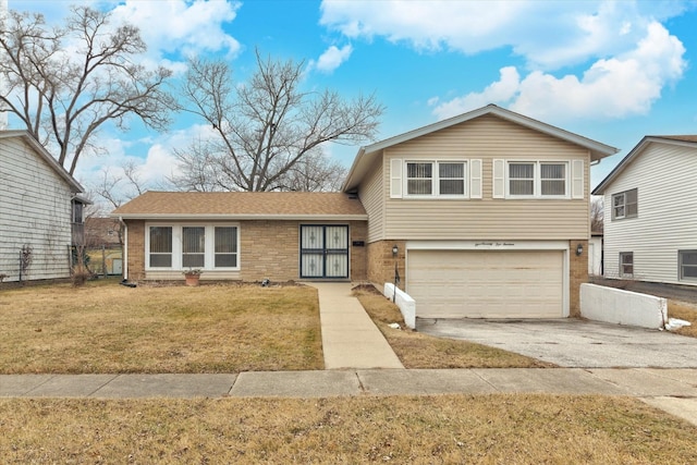 tri-level home featuring a garage and a front lawn