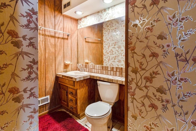 bathroom featuring vanity, toilet, and tile patterned flooring