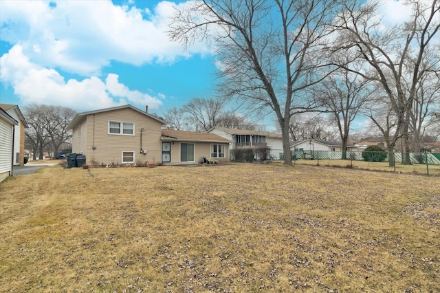 rear view of property with a yard