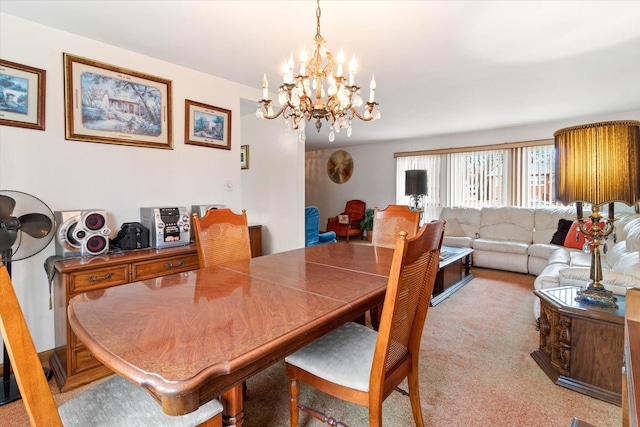 carpeted dining area featuring a chandelier