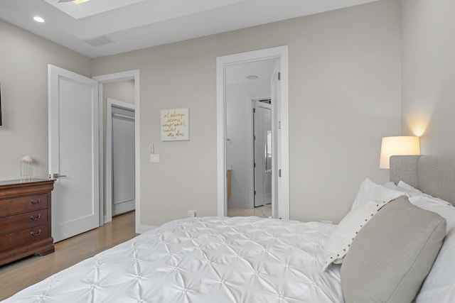 bedroom with light hardwood / wood-style flooring and a skylight