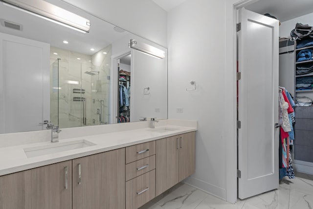 bathroom with vanity and a shower with door